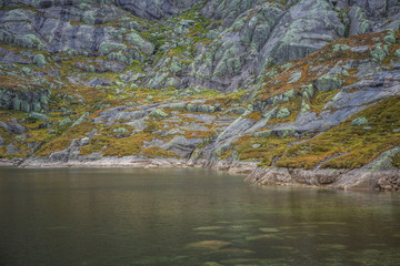A beautiful landscape of a mountain lake in Folgefonna National Park in Norway. Overcast autumn day in mountains. Autumn scenery of lake.