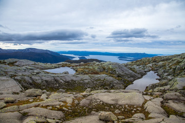 Fototapeta premium A beautiful autumn mountain landscape with a small lake. Natural scenery in Norwegian mountains. Small water pond in mountains.