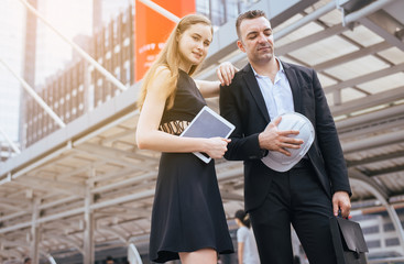 Male and female Architect and construction engineer on building site