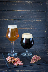 Two glasses of beer. Two types of beer. Dark and light beer.