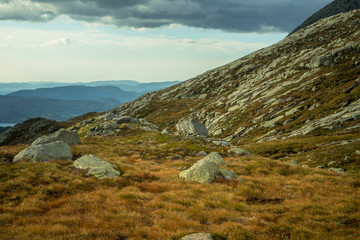 A beautiful autumn landscape in Folgefonna National Park in Norway during a hike in windy, rainy weather. Mountains in Scandinavia. Autumn scenery in wilderness.