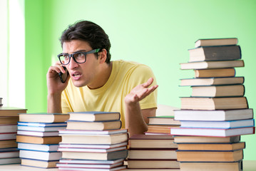 Student with too many books to read before exam