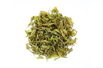 Top view of sun dried Sabah Snake Grass leaves pile isolated on white background. It is tropical herb tea Asian country. Extracting tea help and treat for dietary supplement with drinking healthy.