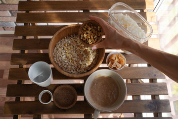 Preparation of granola, cooking process, healthy breakfast idea, vegan, dieting and detox concept.