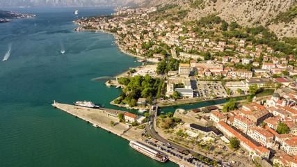 Fototapeta na wymiar Panoramic aerial view of the red tiled roofs of the old town of Kotor and Kotor Bay