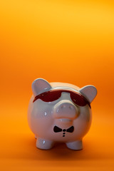 White Pig with glasses money box porcelain on background with copy space