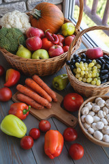 Basket full of mixed of useful vegetables on a wooden background