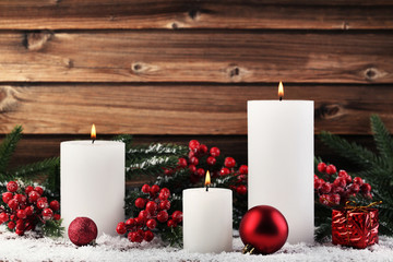 Christmas candles with fir-tree branches and baubles