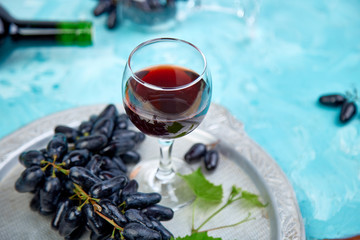 Red wine concept with bottle, glass and grapes
