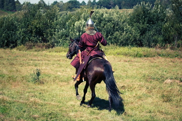 Medieval armored knight on horse from fantasy. Equestrian soldier in historical costume is in the...