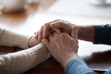 Old middle aged people holding hands close up view, senior retired family couple express care as psychological support concept, trust in happy marriage, empathy hope understanding love for many years - Powered by Adobe