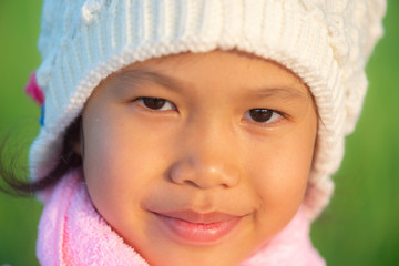 Portrait of young beautiful asian girl outdoor in winter with warm blured sunset light.