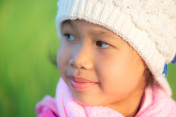 Portrait of young beautiful asian girl outdoor in winter with warm blured sunset light.