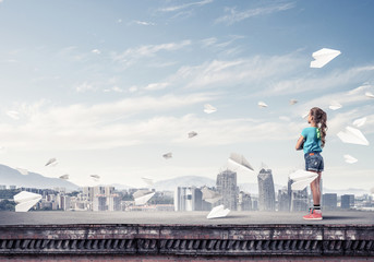 Concept of careless happy childhood with girl looking far away