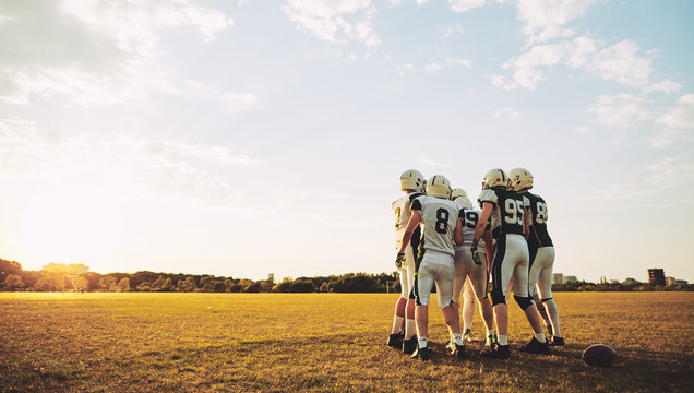 American football players standing on a sportsfield during pract