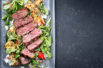Modern Style Italian tagliata di manzo with lamb salad dry aged sliced roast beef as top view in a skillet with copy space right