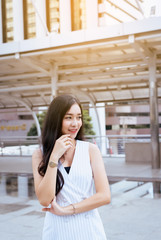 Portrait of beautiful girl smiling and looking something in the street