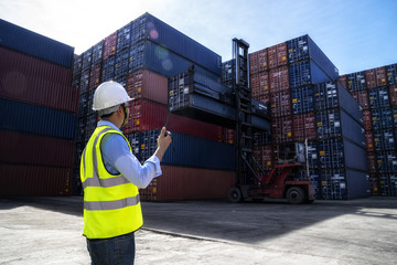 Foreman control loading Containers box to truck for Logistic Import Export Background