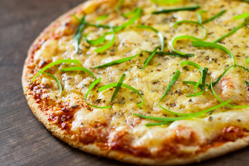 Pizza Margherita or Margarita with Mozzarella cheese. Italian pizza on wooden background
