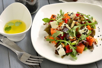 Pumpkin salad with feta, sweet pepper, fresh herbs, almonds and sesame