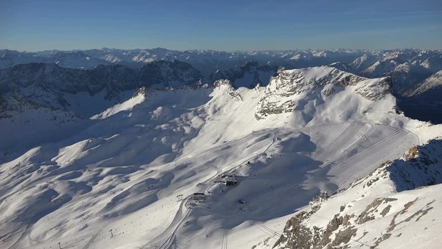 The alpine panorama seen from the summit of Germany's tallest mountain, the Zugspitze, looking southwest including the skiing resort on the Zugspitz glaciers, shot on a beautiful winter's day.