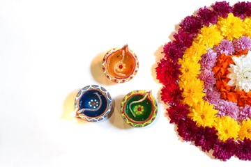 Diwali Flower Rangoli and Clay Diya on white background