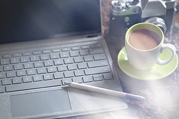 Laptop computer, coffe, old film camera