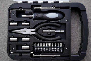 Fototapeta premium Small tool kit with basic tools screw driver tapered nose pliers and spanner for home improvement