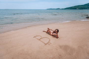 Image of icon bitcoin on golden sand, near sit happy bitcoin girl . Concept freelance, stock exchange