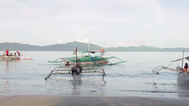 Ultra slow motion shot of traditional filipino bangka boats early morning