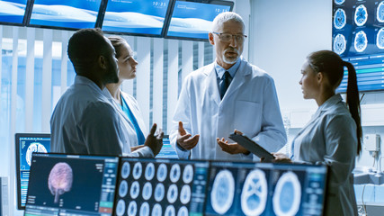 Meeting of the Team of Medical Scientists in the Brain Research Laboratory. Neurologists / Neuroscientists Having Analytical Discussion Surrounded by Monitors Showing CT, MRI Scans. - obrazy, fototapety, plakaty