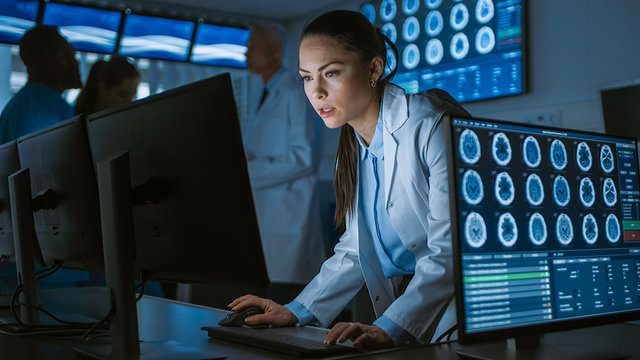 Female Scientist / Neurologist Working on a Personal Computer in Modern Laboratory. Medical Research Scientists Making New Discoveries in the fields of Neurophysiology, Science