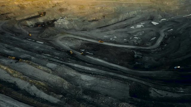 Opencast mining footage. Aerial quarry shot from copter. Industrial vehicles.