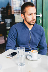 Young man sitting in a coffee bar  