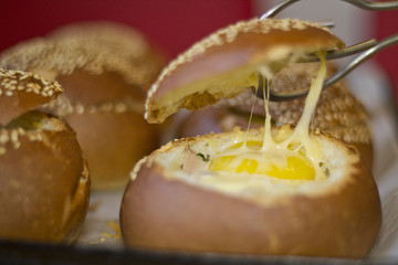 Buns with liquid egg, bacon and melted cheese.Egg, cheese and bacon sandwiches. Hot breakfast.