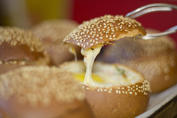 Buns with liquid egg, bacon and melted cheese.Egg, cheese and bacon sandwiches. Hot breakfast.