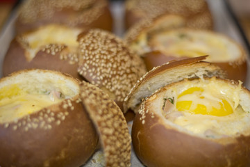 Buns with liquid egg, bacon and melted cheese.Egg, cheese and bacon sandwiches. Hot breakfast.