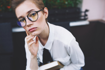 business woman with glasses on the street looking into the camera portrait