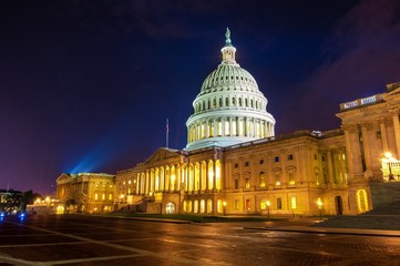 Spot light illuminates the domed marble United States Capital building in Washington DC at night