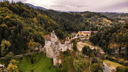 Fototapeta na wymiar Aerial view of Bran castle in beautiful Transylvania, region of Romania. Cloudy day with dark clouds