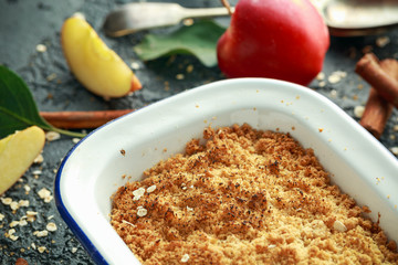 Traditional English apple crumble baked in vintage dish and served with cream