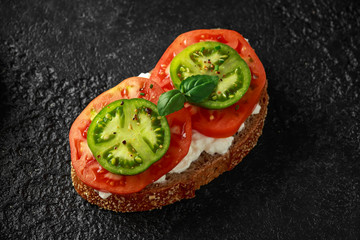 Vegetarian Healthy bread toasts with cottage cheese, heirloom tomatoes, scrambled eggs and avocado