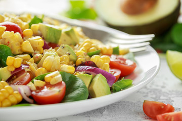 Sweet Corn salad with tomatoes, avocado, red onion, herbs and lime