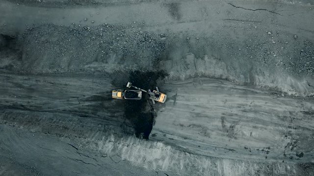 Aerial quarry shot from quadrupter. Industrial vehicles overall plan.