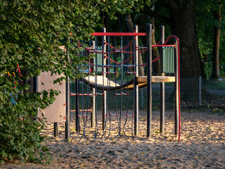 Image of wooden playgound on sandy ground