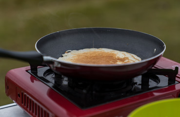 Pancake is cooked on a gas stove