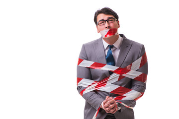 Businessman tied by tape isolated on white