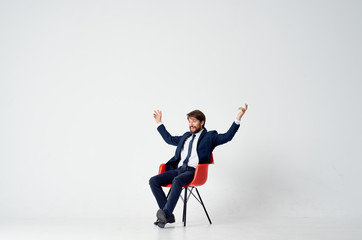 business man sitting on a red chair in the office