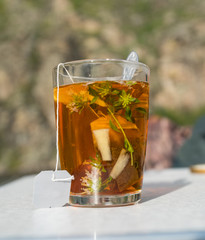 A glass of herbal tea with mint and ginger