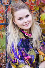 A young blonde woman in autumn park